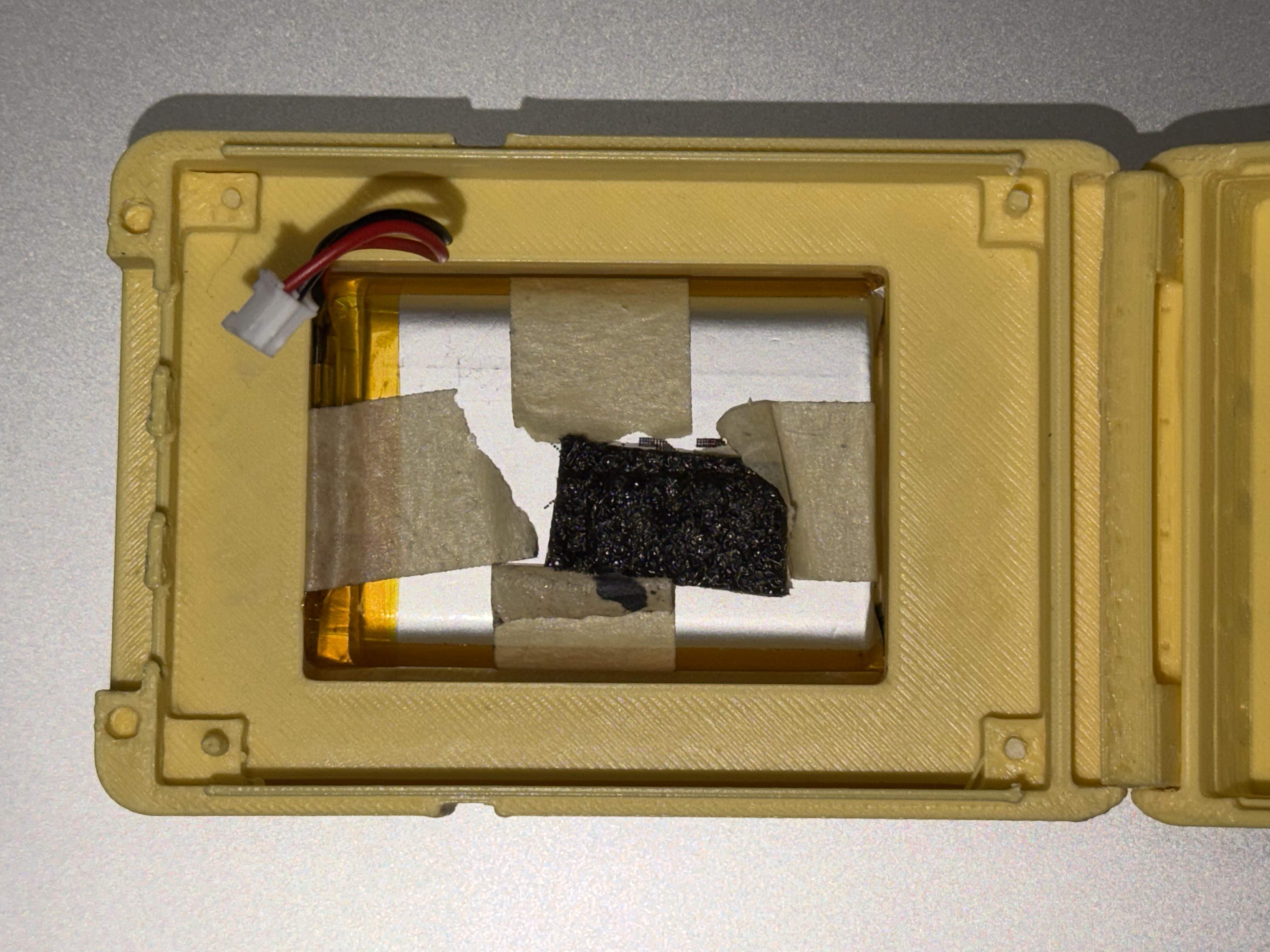 Battery compartment with LiPo battery seated in dedicated slot, foam padding